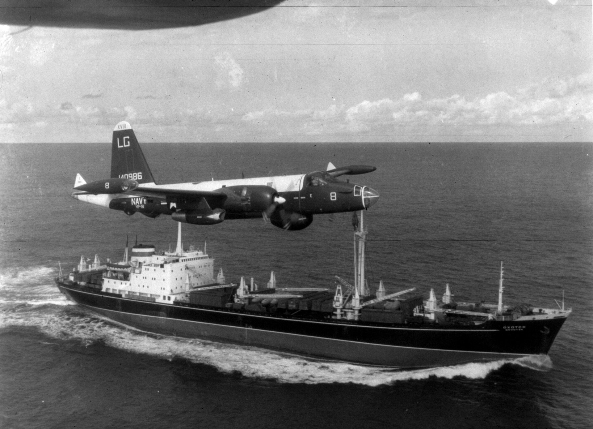 A U.S. Navy patrol aircraft flies low above a Soviet freighter at sea during the quarantine.