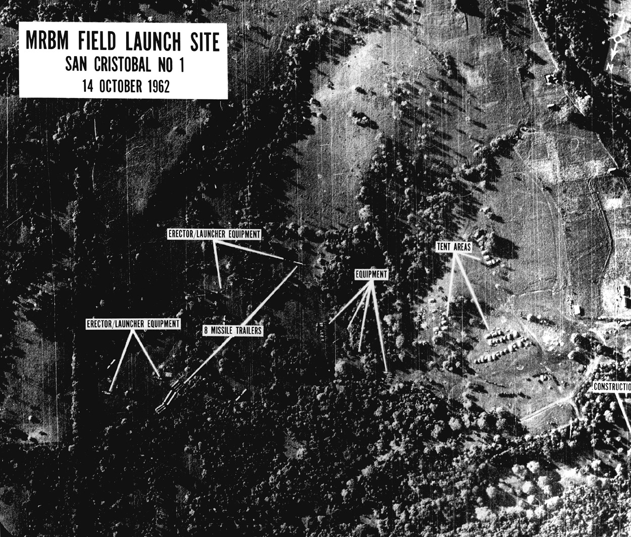 An annotated black-and-white aerial photograph identifies missile equipment and construction at a Cuban site.