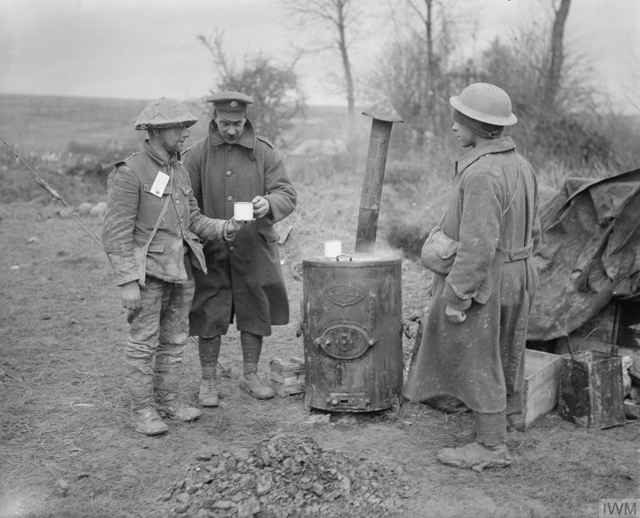 British soldiers move through heavily damaged ground during the Battle of the Somme.