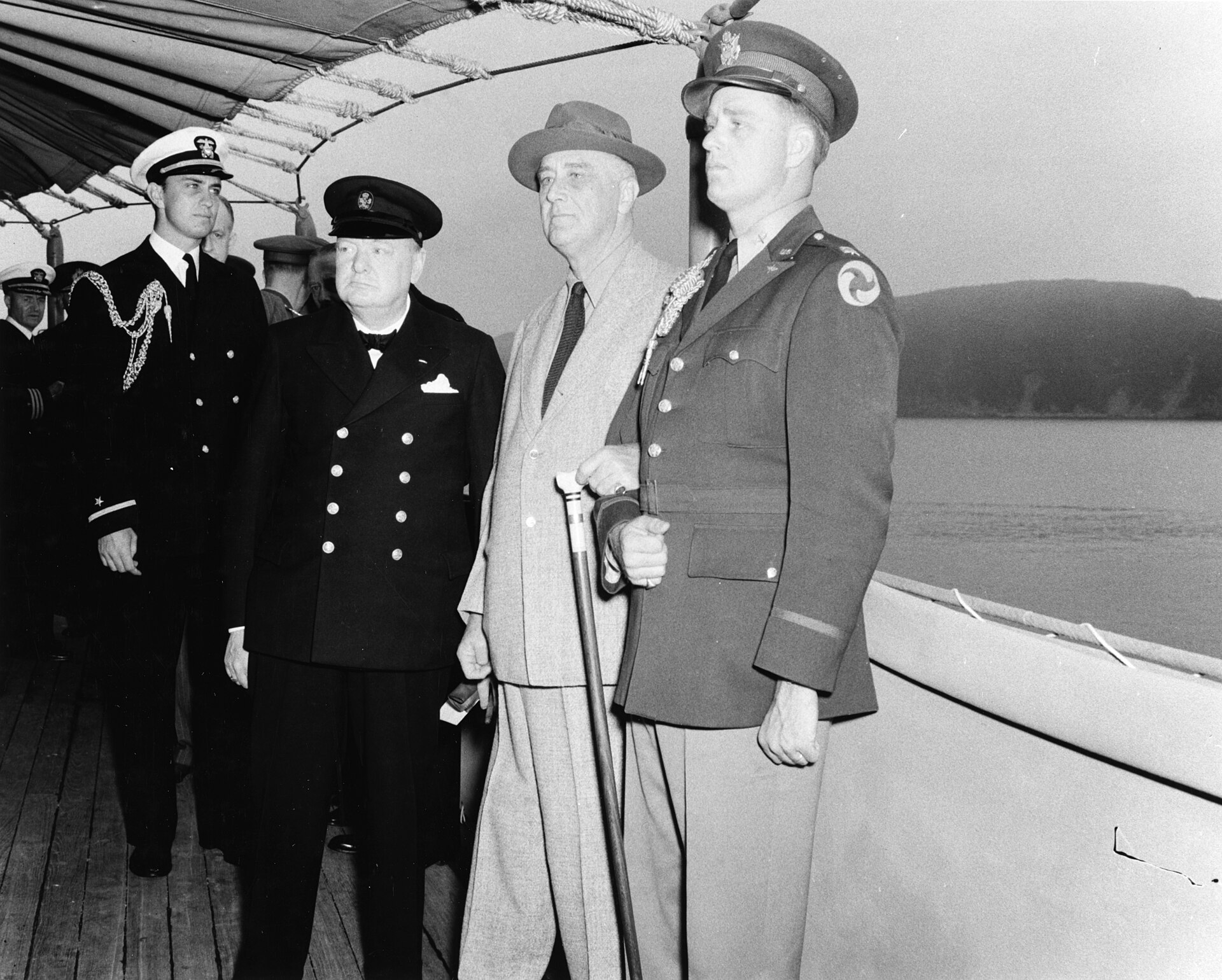 Winston Churchill and Franklin Roosevelt sit together aboard USS Augusta during the Atlantic Conference.