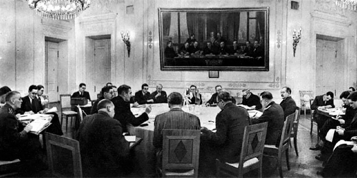 Soviet, British, and American officials sit around a conference table during the 1943 Moscow Conference.