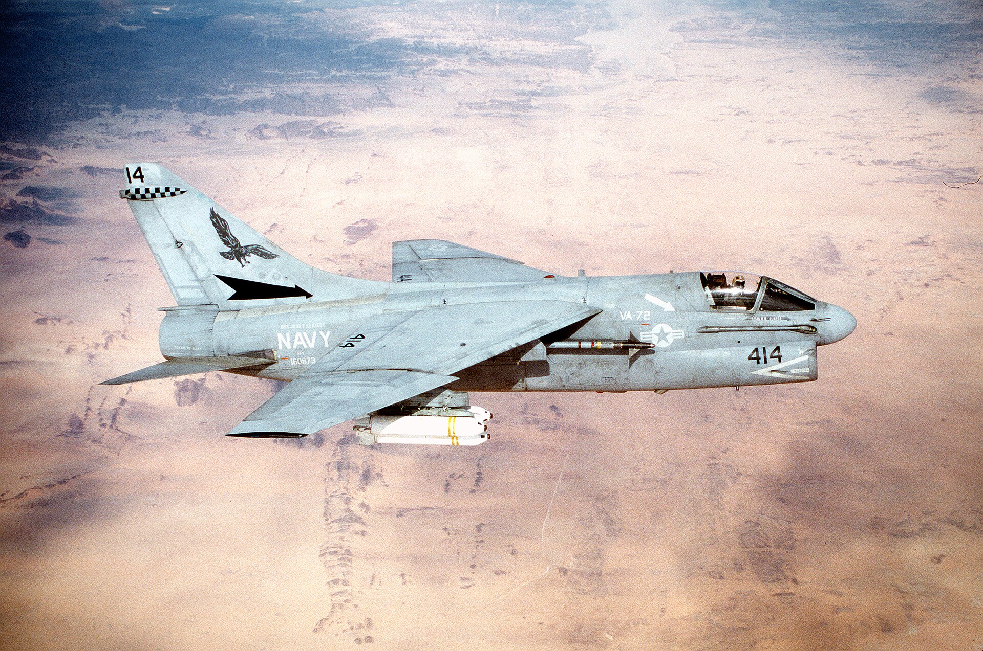 A United States Navy A-7E Corsair II flies above the desert while carrying weapons during Operation Desert Storm.