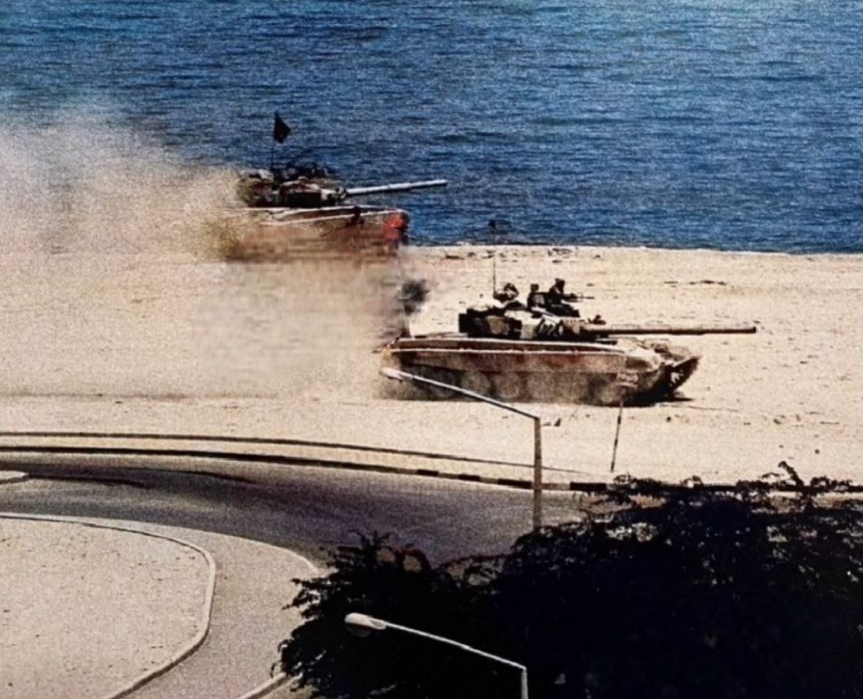An Iraqi T-72 main battle tank fires near the Kuwaiti coastline during the opening invasion.