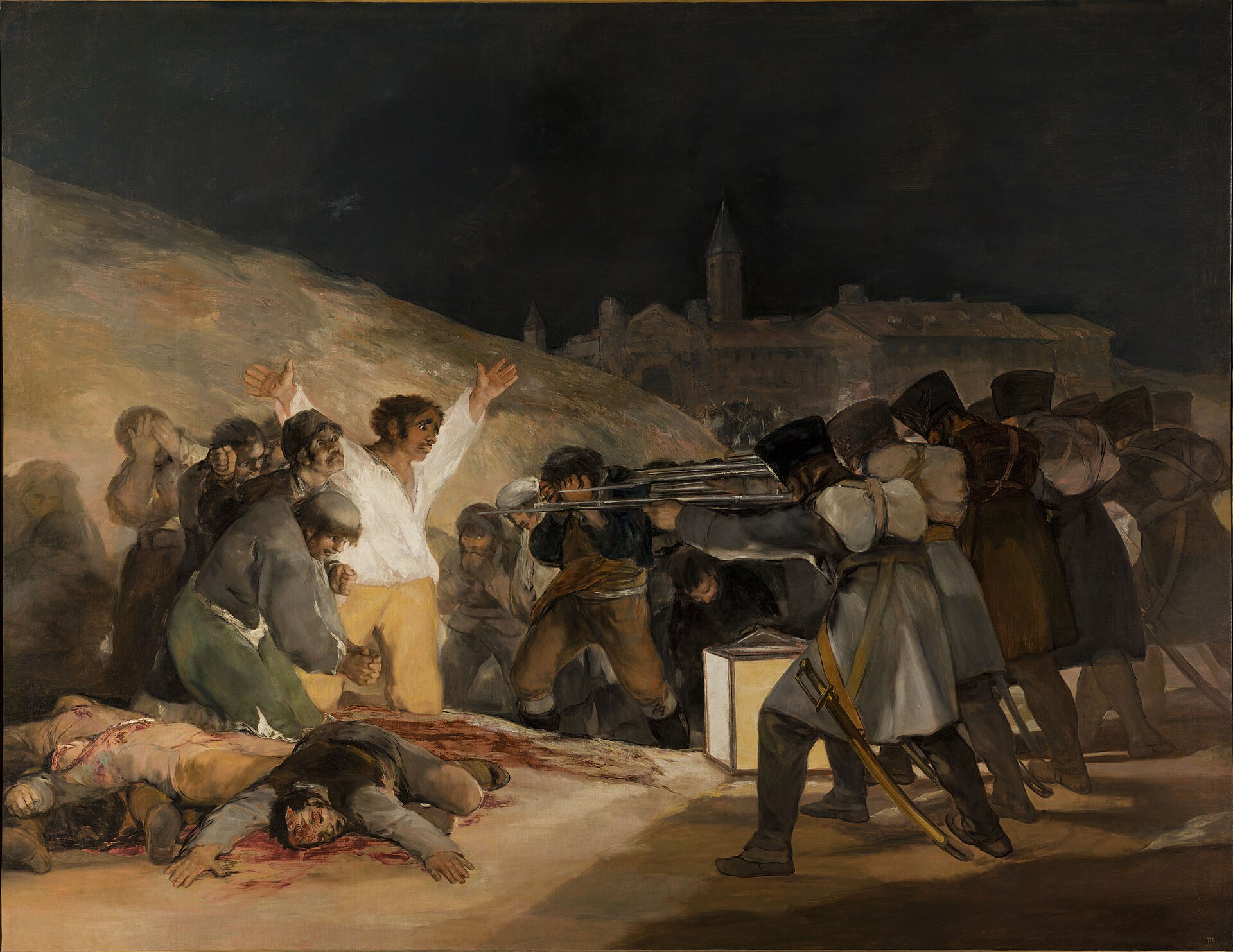 A man in a white shirt throws his arms wide before a firing squad by lantern light, the bodies of the already shot at his feet.
