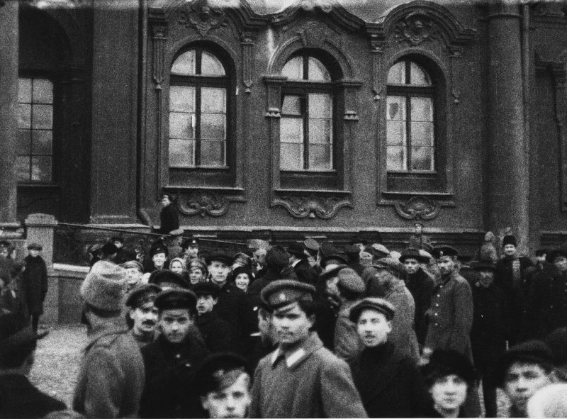 Armed men stand inside a damaged room in the Winter Palace after Bolshevik forces captured it.