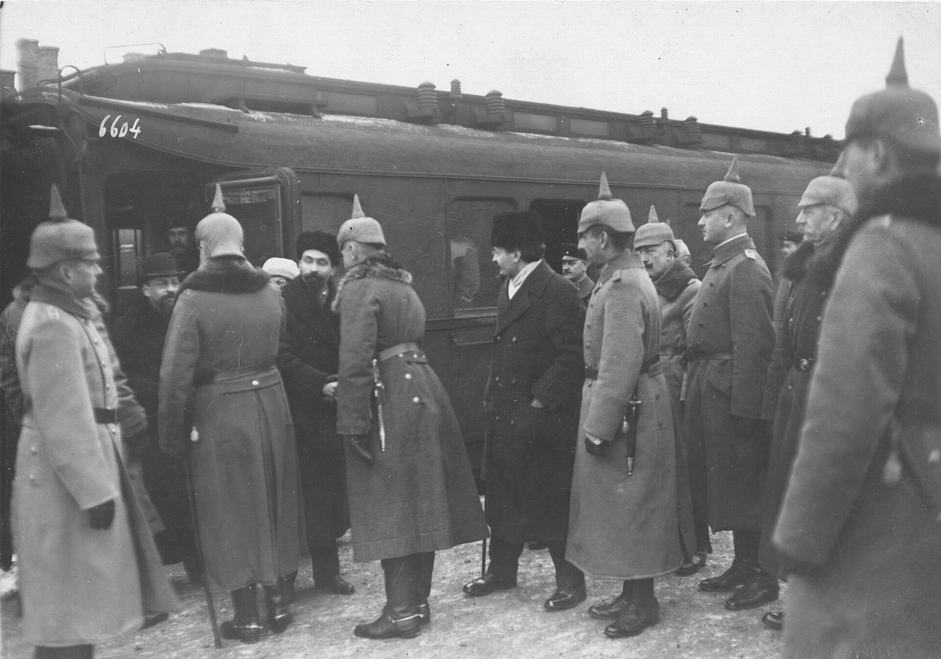 Leon Trotsky and other Russian delegates walk past a guard of honor after arriving for peace negotiations at Brest-Litovsk.