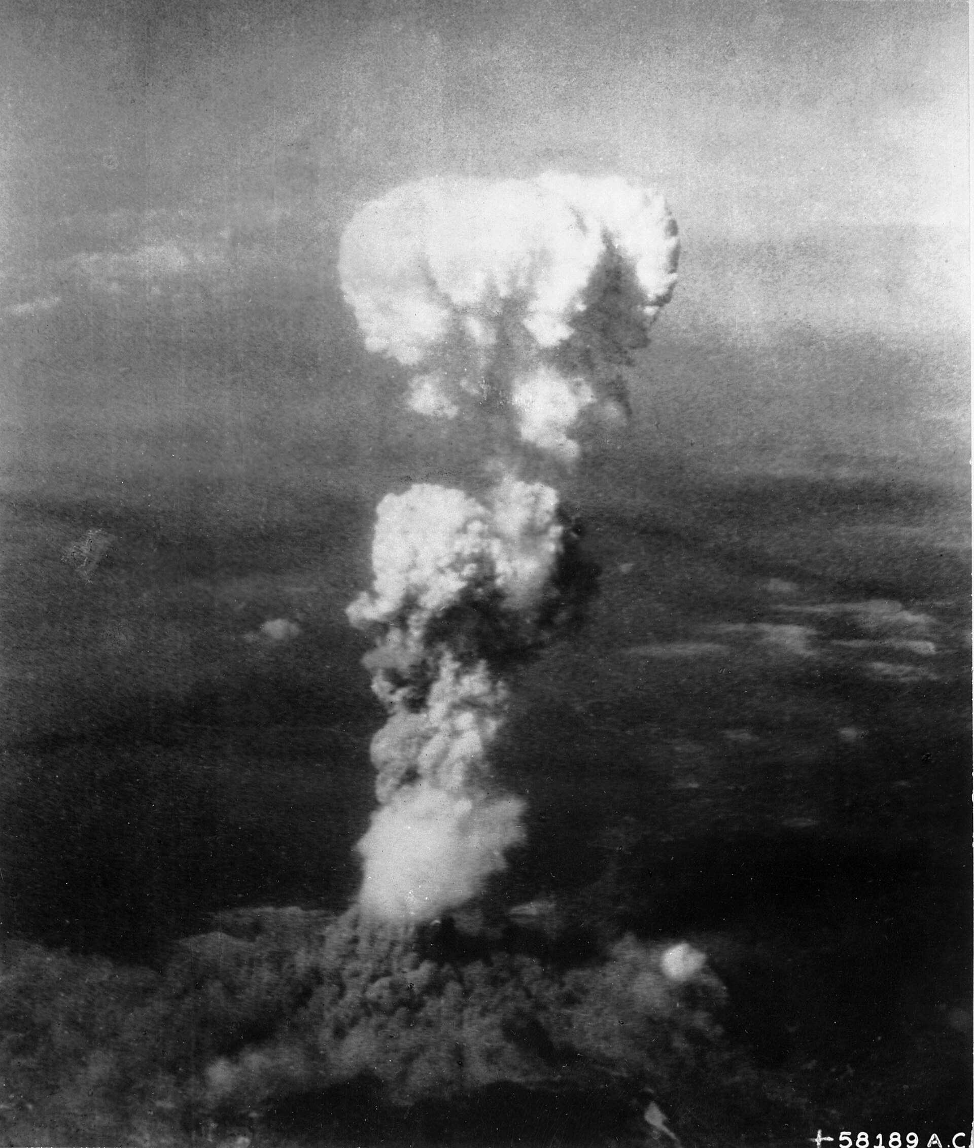 A vast mushroom cloud rises above Hiroshima after the atomic bombing.