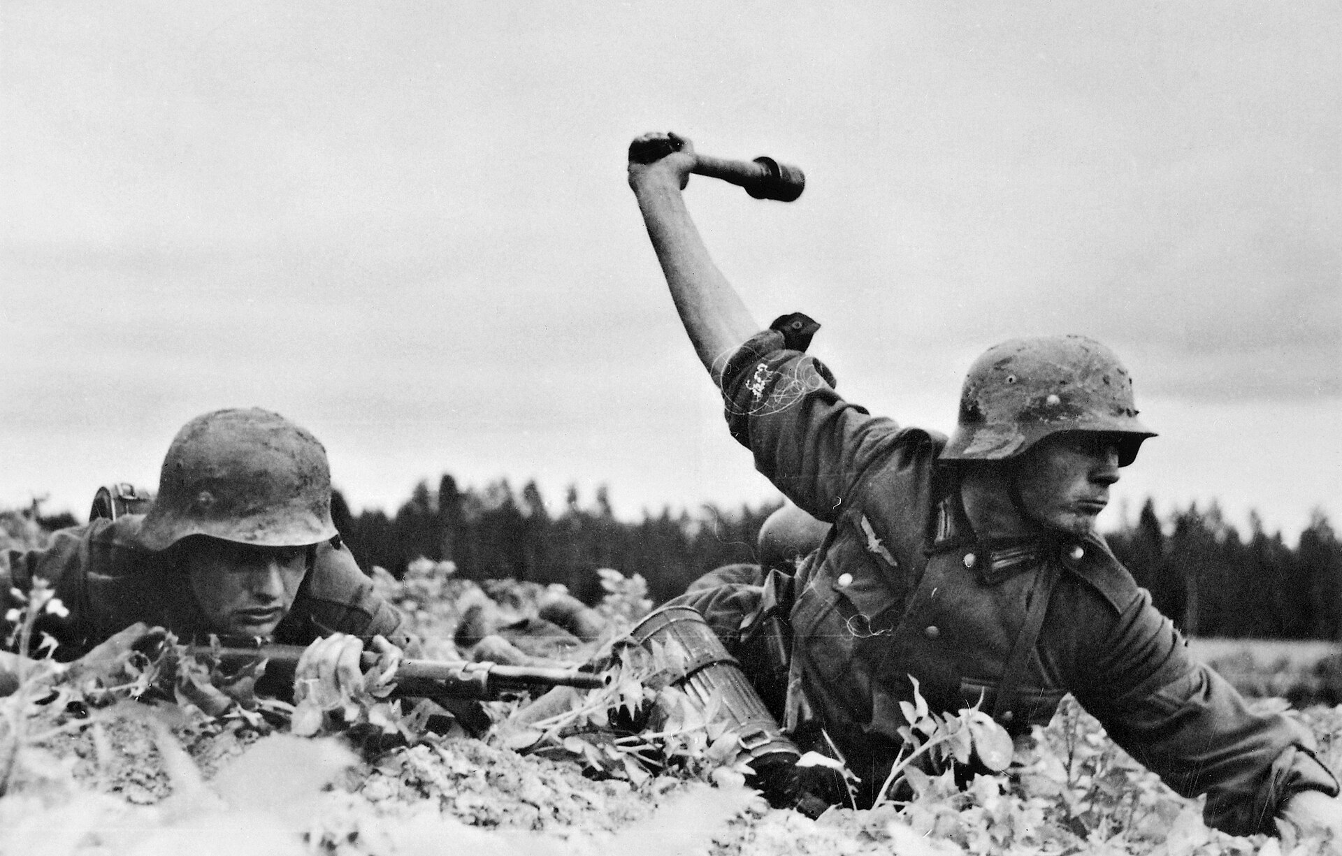 German soldiers and vehicles advance along a rough road in the Soviet Union in 1941.