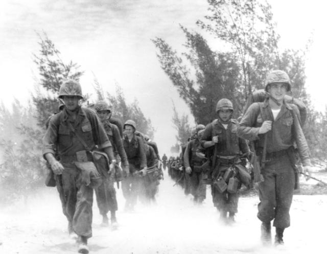 United States Marines and landing craft crowd a beach at Da Nang during the arrival of the 9th Marine Expeditionary Brigade.